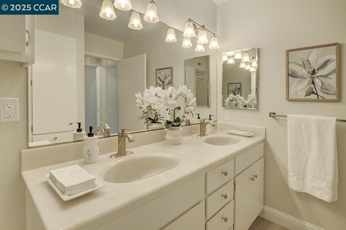 2900 Tice Creek Drive, Unit 1 & 3 Walnut Creek, CA 94595 - Photo 37 of 58 a bathroom with double vanity sinks a vanity two mirror and a shower