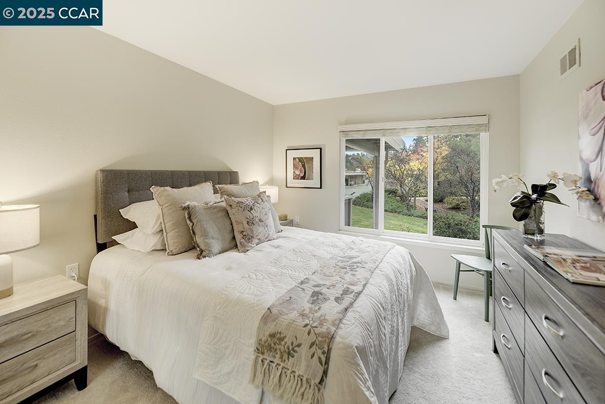 2900 Tice Creek Drive, Unit 1 & 3 Walnut Creek, CA 94595 - Photo 44 of 58 a bedroom with a bed and a large window
