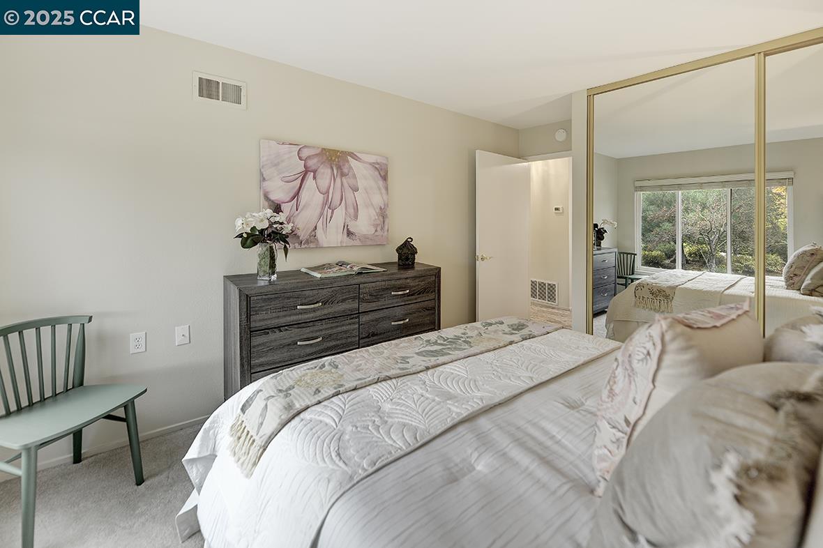 2900 Tice Creek Drive, Unit 1 & 3 Walnut Creek, CA 94595 - Photo 46 of 58 a bedroom with a bed and wooden floor