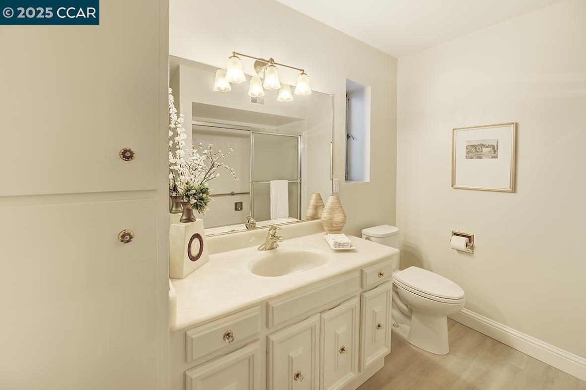2900 Tice Creek Drive, Unit 1 & 3 Walnut Creek, CA 94595 - Photo 47 of 58 a bathroom with a sink a toilet and mirror