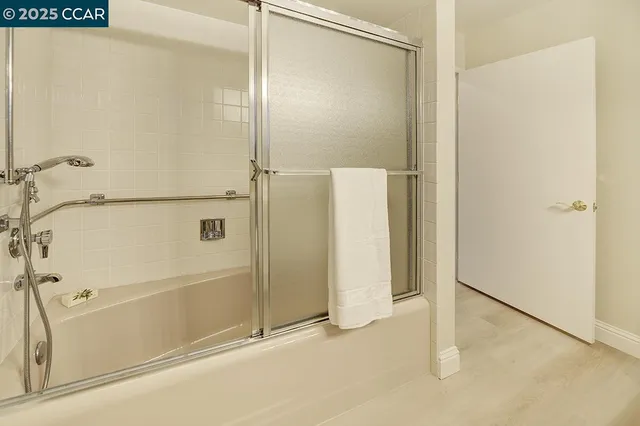 a view of a hallway with wooden floor and entryway