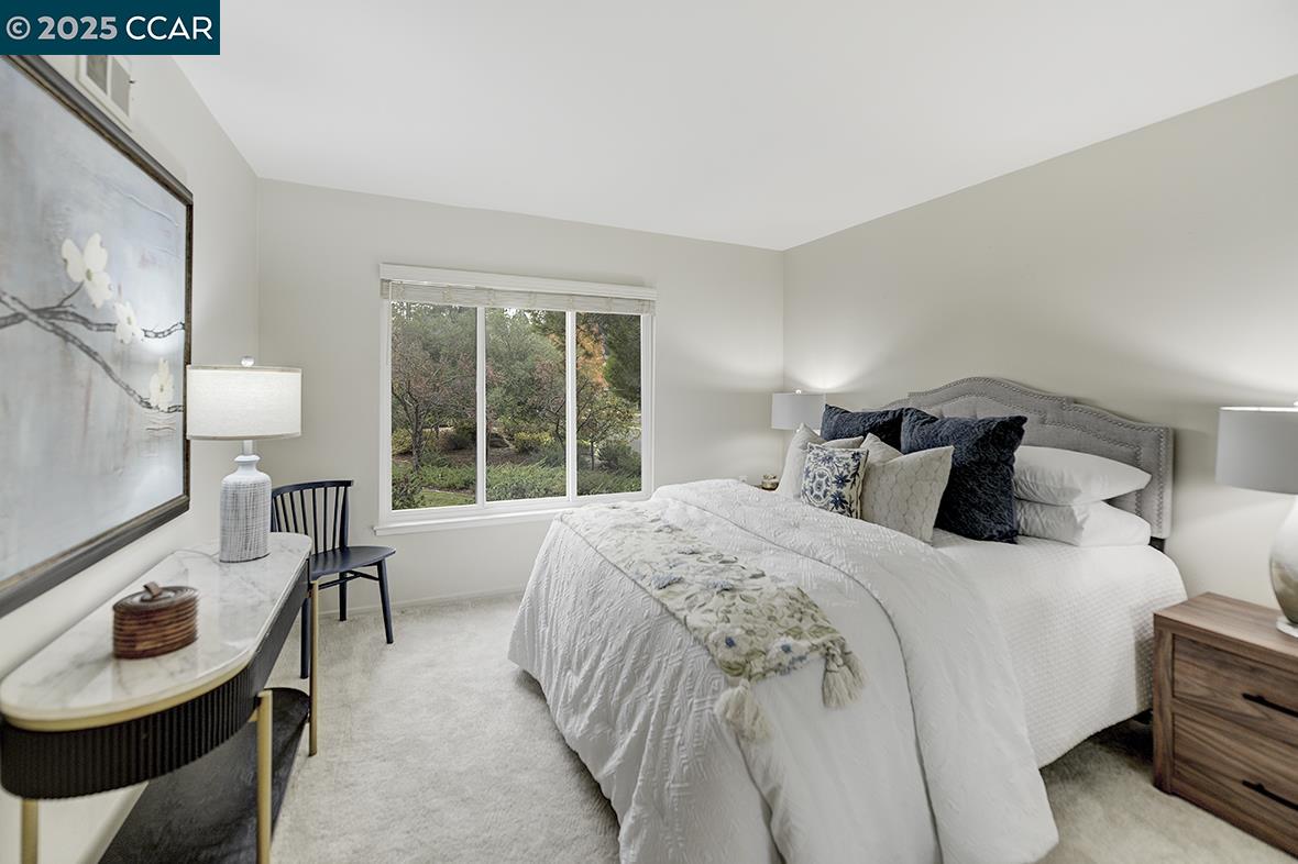 2900 Tice Creek Drive, Unit 1 & 3 Walnut Creek, CA 94595 - Photo 49 of 58 a bedroom with a bed and a table