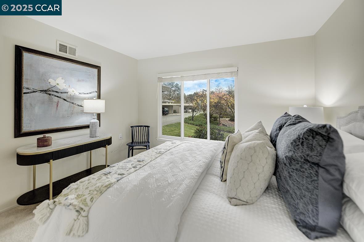 2900 Tice Creek Drive, Unit 1 & 3 Walnut Creek, CA 94595 - Photo 50 of 58 a bed sitting in a bedroom next to a window