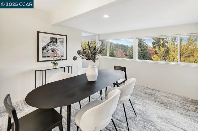 a view of a dining room with furniture window and outside view
