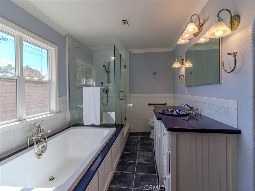 802 Renee Street Redlands, CA 92374 - Photo 9 of 18 a bathroom with a sink a toilet and a mirror