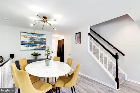 a view of a dining room with furniture wooden floor and chandelier