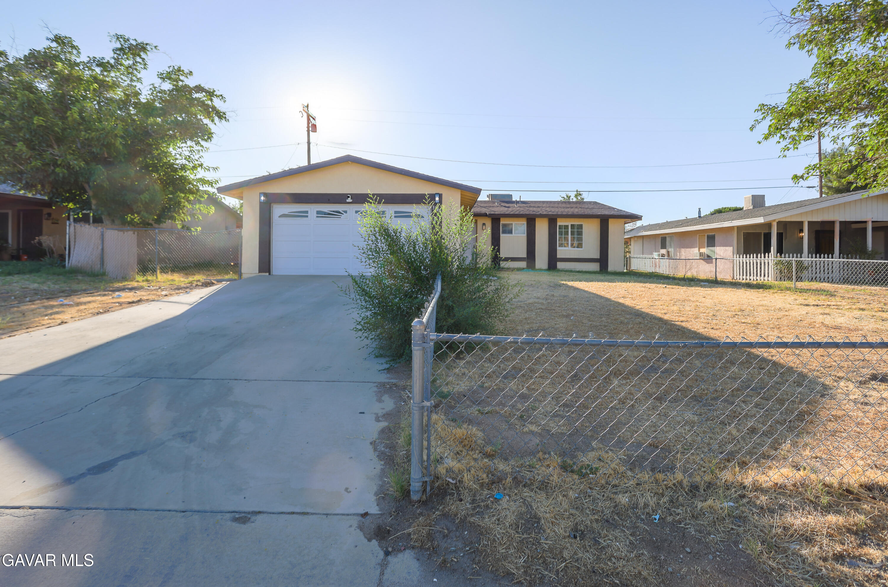 3340 West Roxbury Street Rosamond, CA 93560 - Photo 1 of 20 a front view of a house with a yard and trees