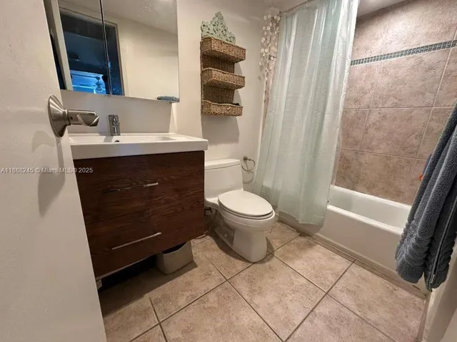 a bathroom with a sink a toilet a mirror and shower