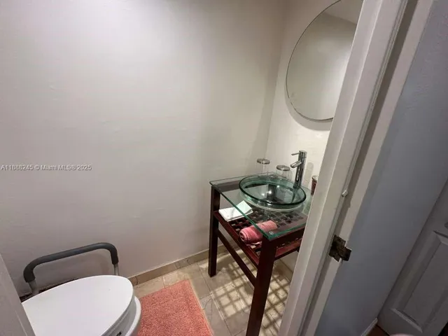 a bathroom with a toilet and a mirror