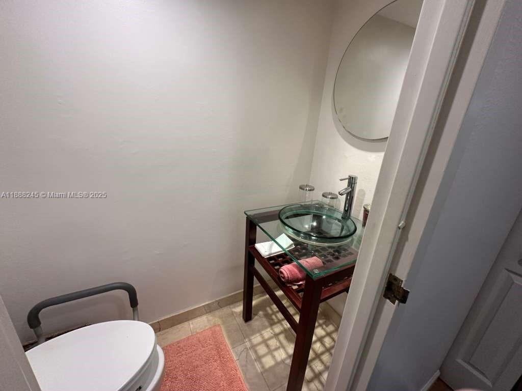 1000 Parkview Drive, Unit 627 Hallandale Beach, FL 33009 - Photo 13 of 27 a bathroom with a toilet and a mirror