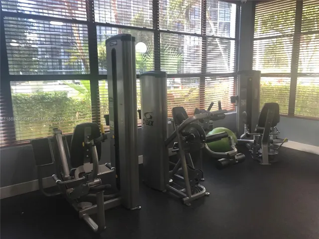 a view of a livingroom with furniture and floor to ceiling window
