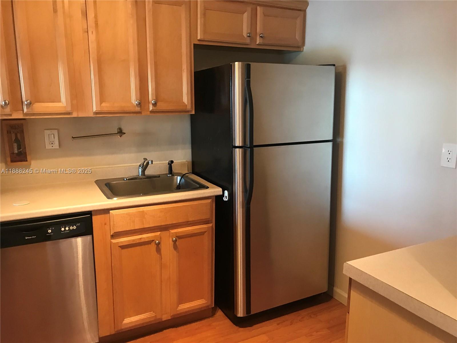 1000 Parkview Drive, Unit 627 Hallandale Beach, FL 33009 - Photo 2 of 27 a kitchen with a refrigerator and a sink