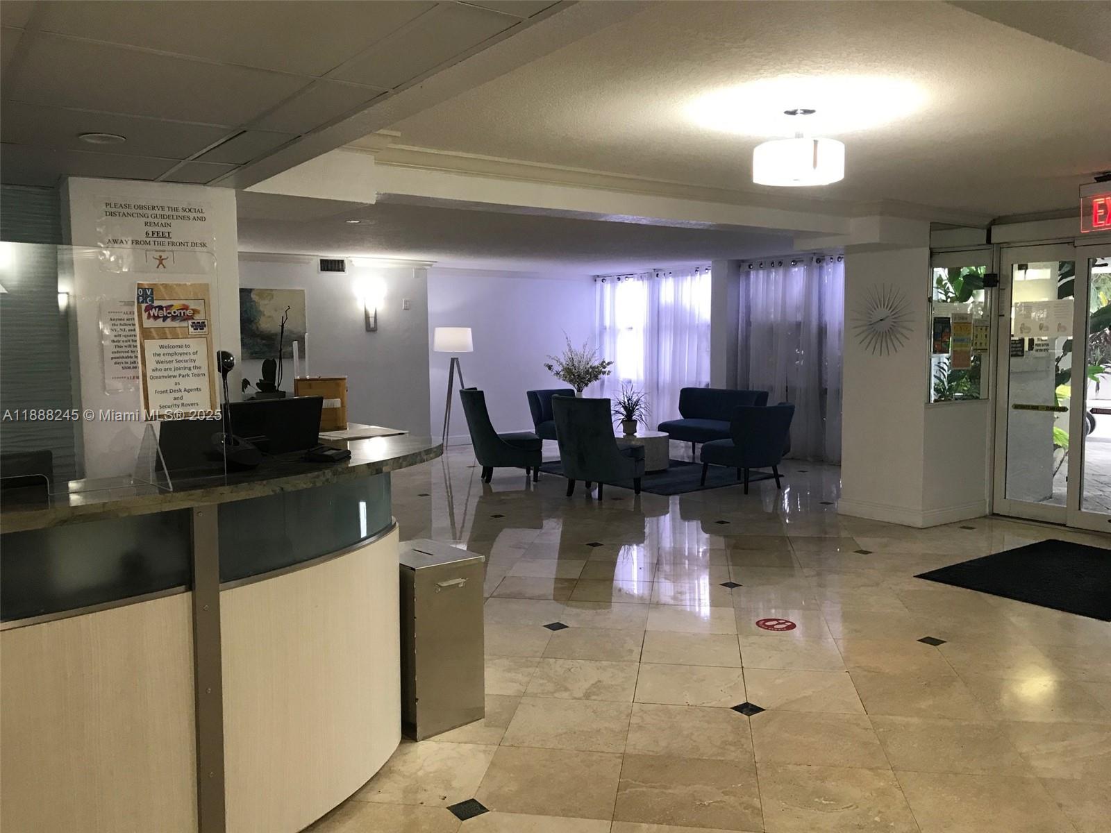 1000 Parkview Drive, Unit 627 Hallandale Beach, FL 33009 - Photo 22 of 27 a kitchen with stainless steel appliances kitchen island granite countertop dining table chairs and a refrigerator