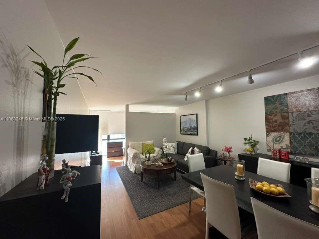 1000 Parkview Drive, Unit 627 Hallandale Beach, FL 33009 - Photo 5 of 27 a living room with furniture and a flat screen tv