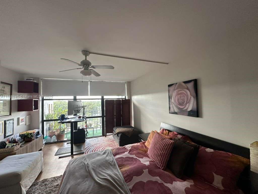 1000 Parkview Drive, Unit 627 Hallandale Beach, FL 33009 - Photo 7 of 27 a bedroom with furniture and a chandelier