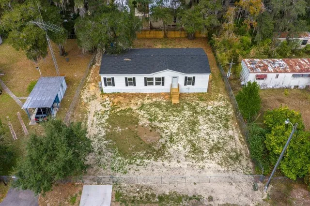 an aerial view of a house with a yard