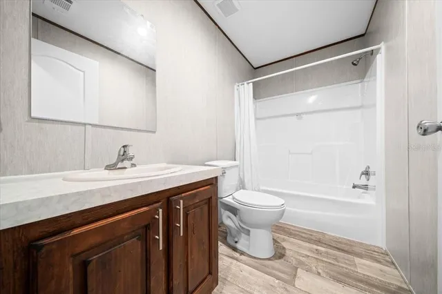 a view of a small space with wooden floor and a window