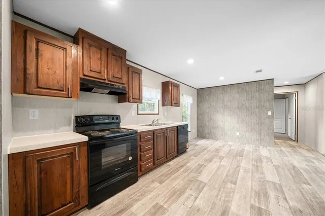 a kitchen with stainless steel appliances granite countertop a stove and a sink