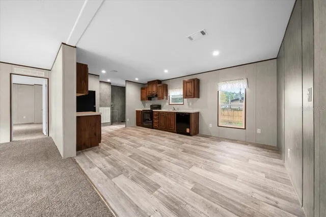 a view of a kitchen with a sink and a refrigerator