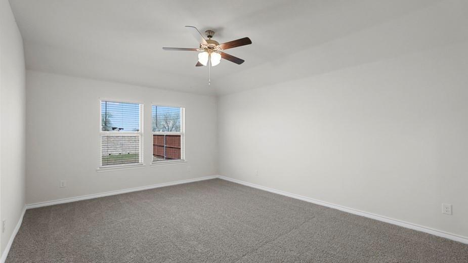 439 Epiphany Lane Lavon, TX 75166 - Photo 21 of 31 Spacious room with light gray wall paint, gray carpet flooring, and white trim