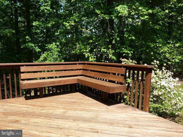 12351 Lima Lane Reston, VA 20191 - Photo 21 of 28 a wooden bench sitting in the middle of a yard