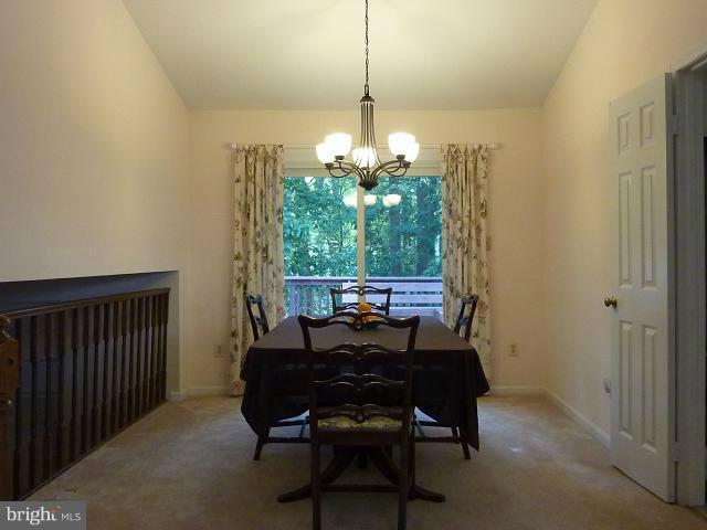 12351 Lima Lane Reston, VA 20191 - Photo 22 of 28 a view of a dining room with furniture and a chandelier