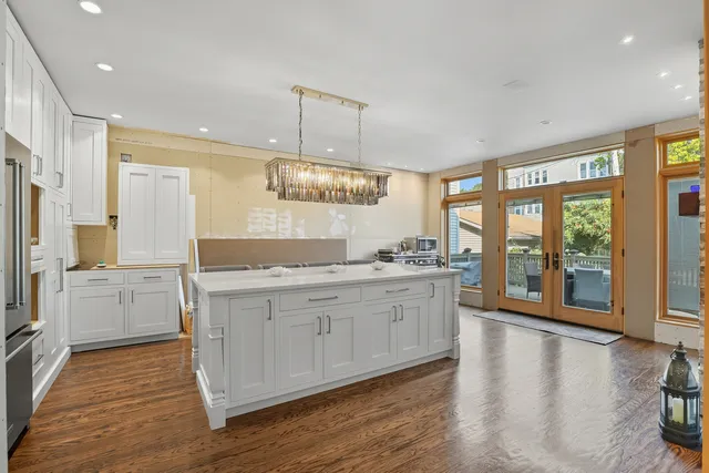 a large kitchen with a large window and stainless steel appliances