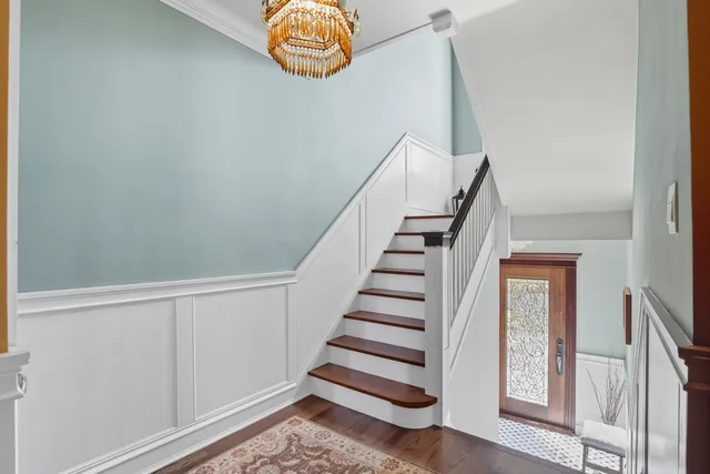 a view of entryway with stairs and wooden floor