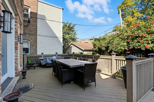 a view of a dinning table and chairs in patio of the house