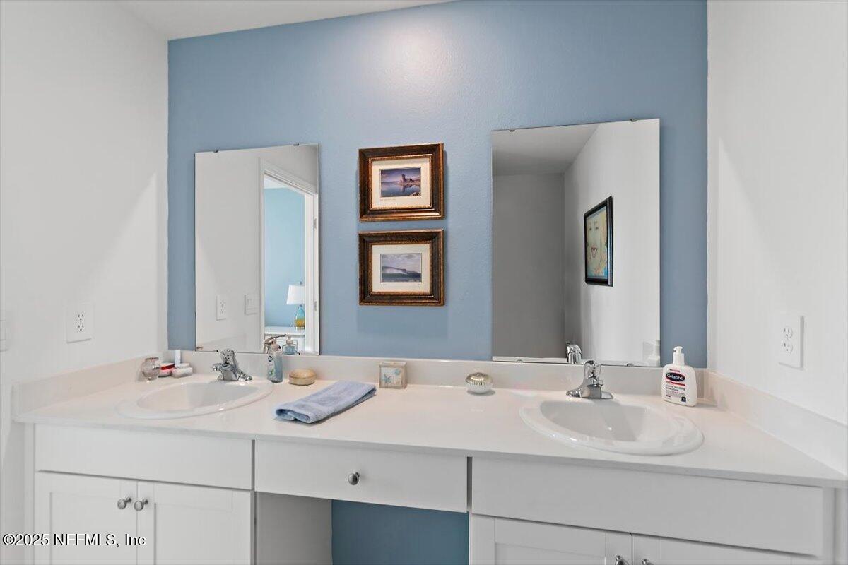 120 Seaport Breeze Rd Street St. Augustine, FL 32095 - Photo 11 of 25 a bathroom with double sink and a mirror