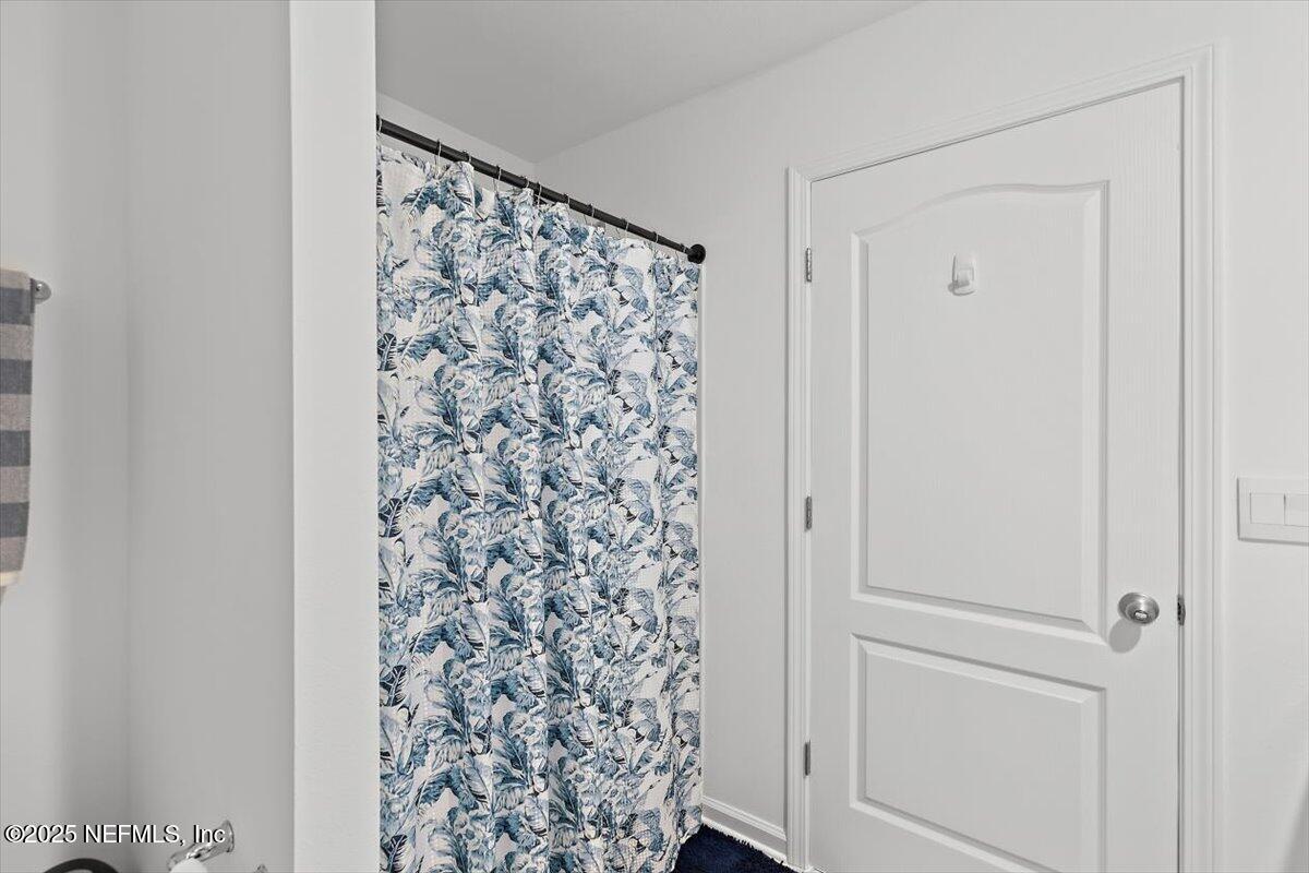 120 Seaport Breeze Rd Street St. Augustine, FL 32095 - Photo 12 of 25 a view of bathroom with shower curtain