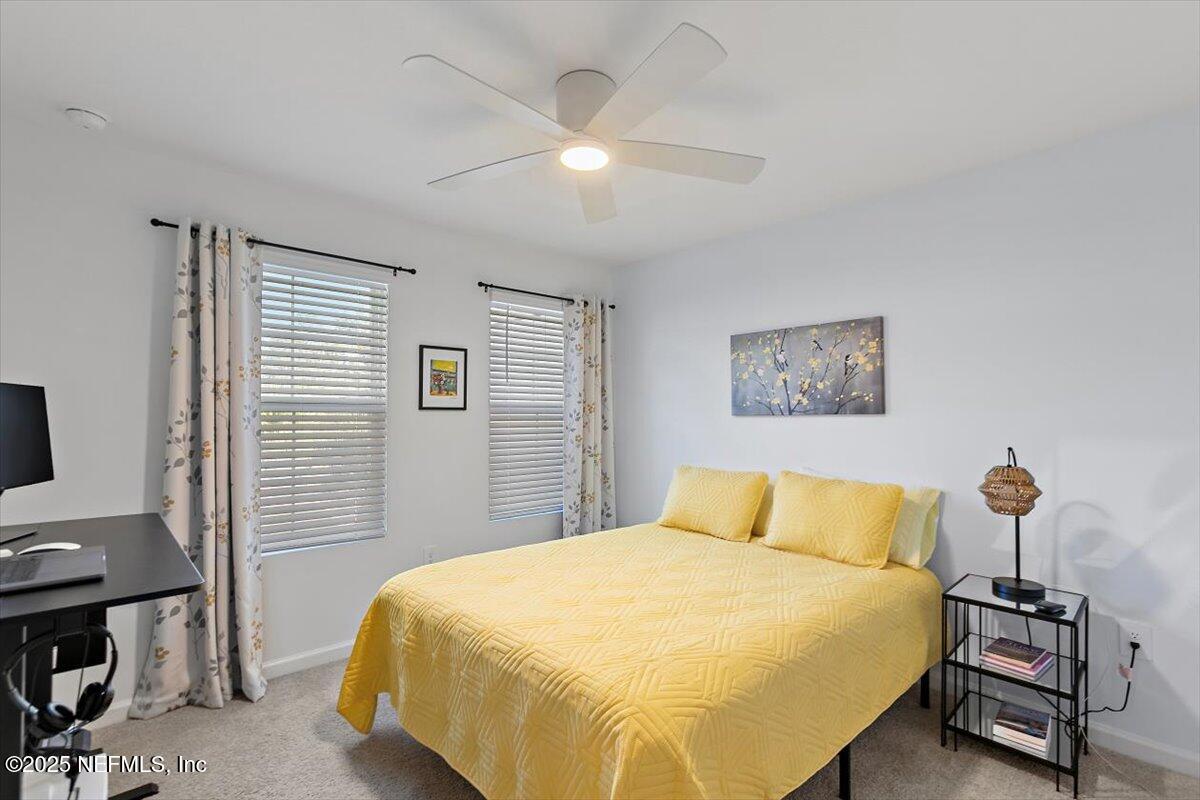 120 Seaport Breeze Rd Street St. Augustine, FL 32095 - Photo 13 of 25 a bedroom with a bed and a chandelier