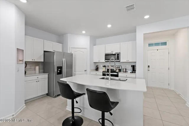 a kitchen with stainless steel appliances a refrigerator stove microwave and cabinets