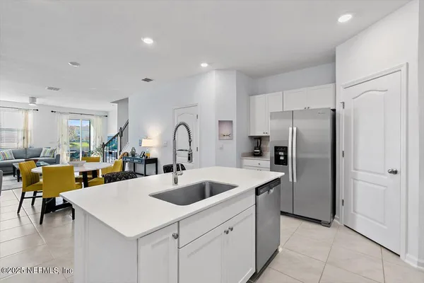 a kitchen with a refrigerator and a sink