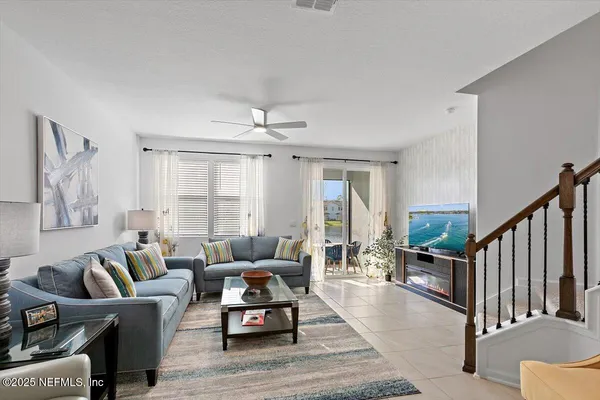 a living room with furniture and a large window