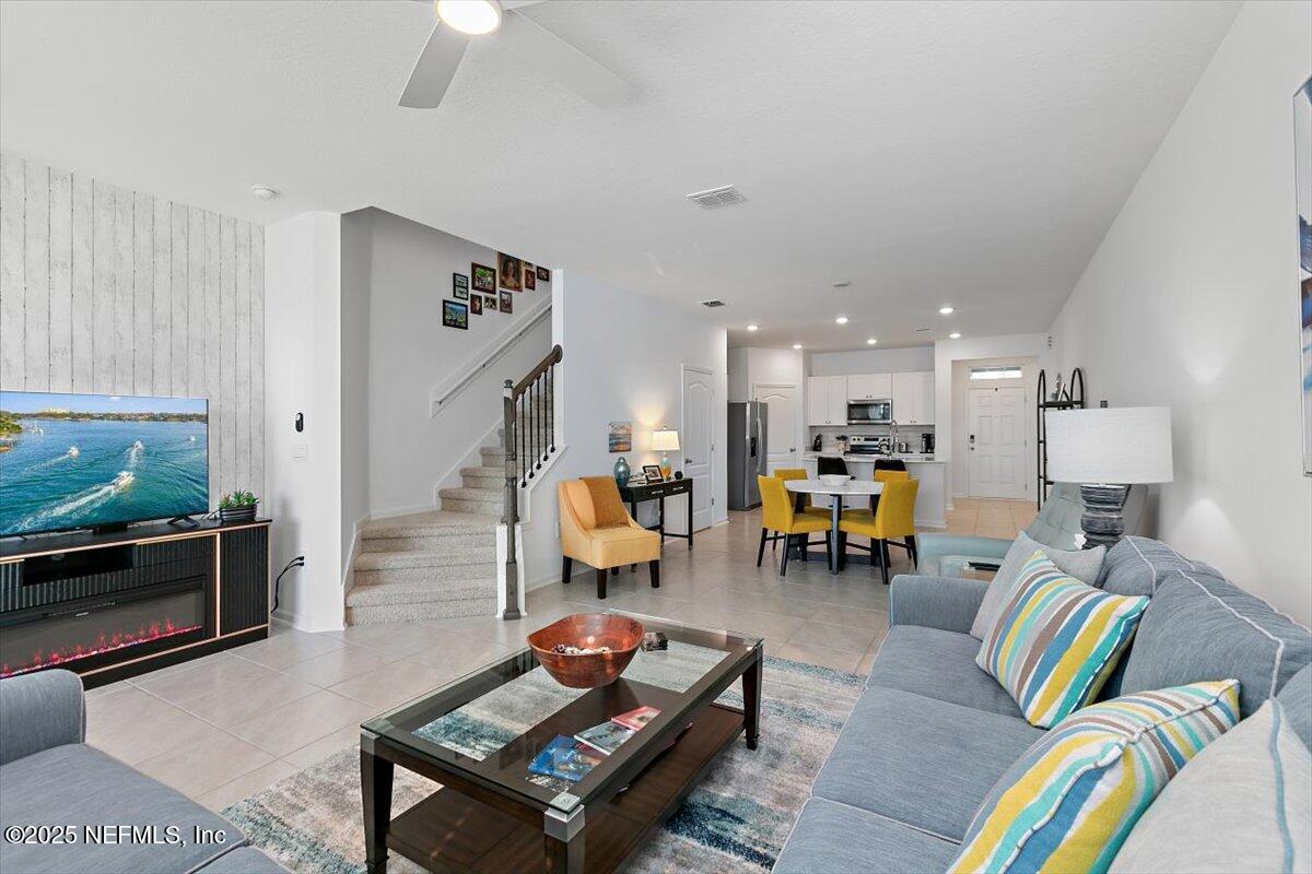 120 Seaport Breeze Rd Street St. Augustine, FL 32095 - Photo 9 of 25 a living room with furniture and a fireplace