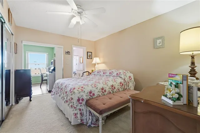 a bedroom with a bed and a lamp on dresser