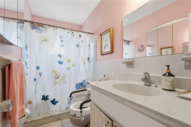 a bathroom with a sink a toilet and shower curtain