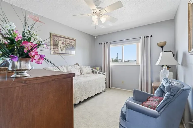 a living room with furniture and flowers