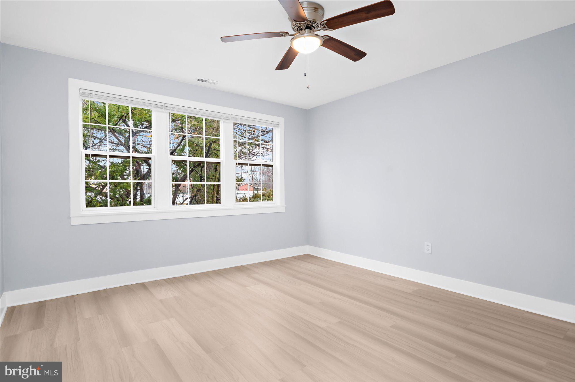 733 West County Line Road Horsham, PA 19044 - Photo 14 of 24 a view of an empty room with wooden floor and a window