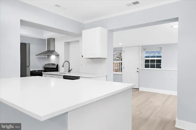 a kitchen with a stove a sink and a refrigerator