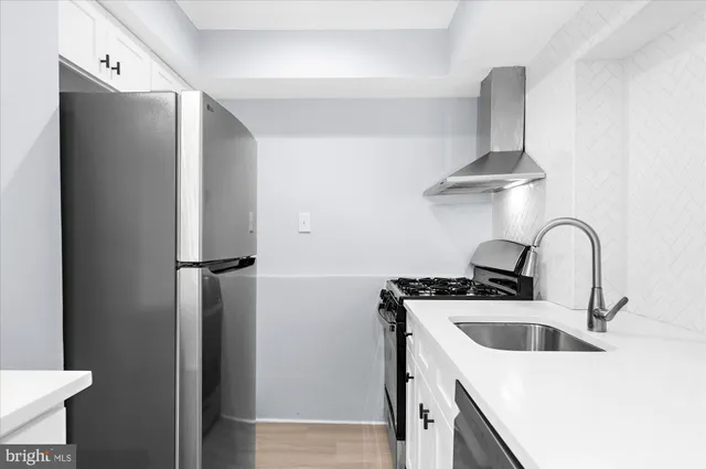 a kitchen with stainless steel appliances a sink and a refrigerator
