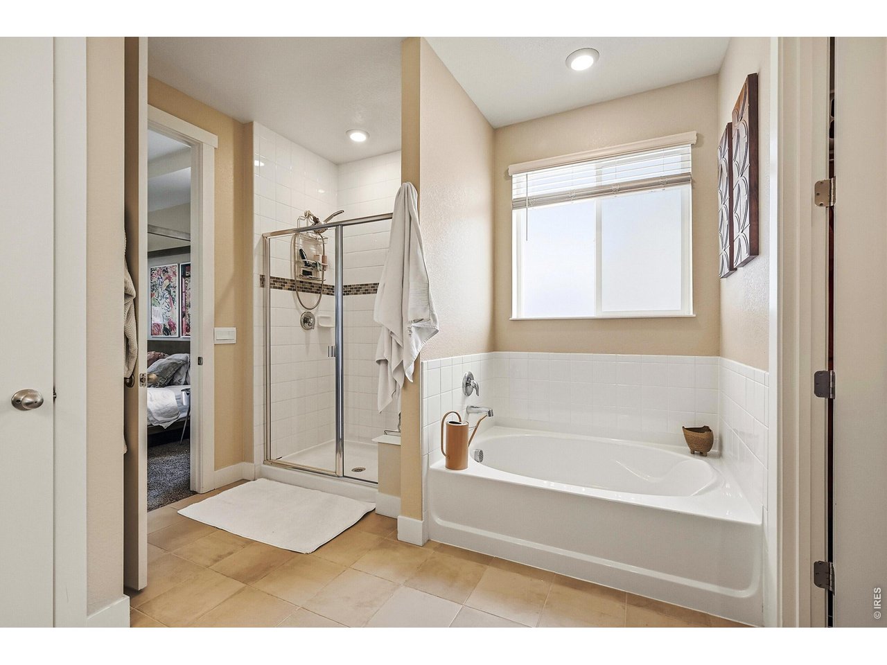 1699 Rivergate Way Berthoud, CO 80513 - Photo 15 of 45 a bathroom with a bathtub and a shower