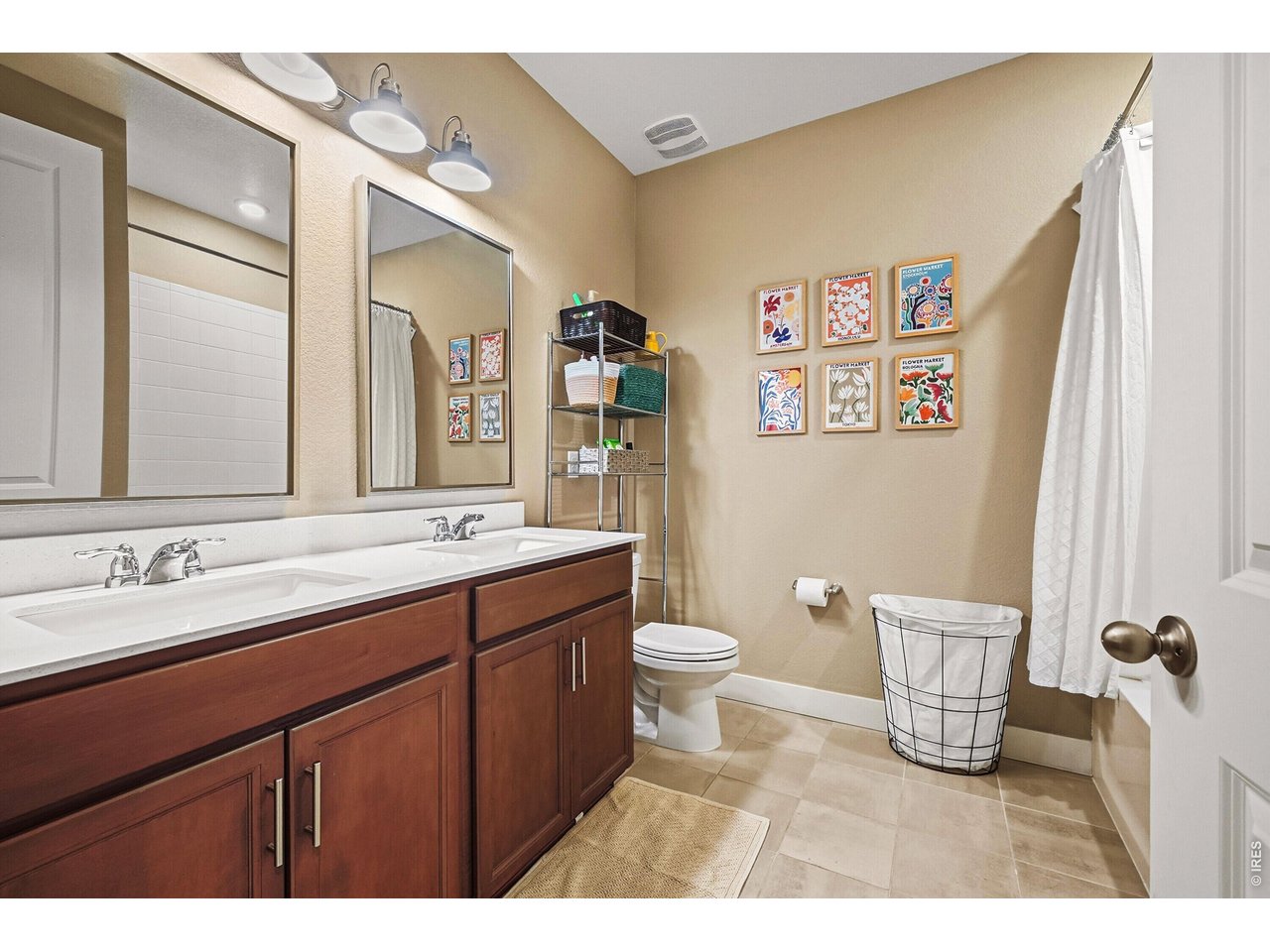 1699 Rivergate Way Berthoud, CO 80513 - Photo 17 of 45 a bathroom with a sink a toilet and a mirror