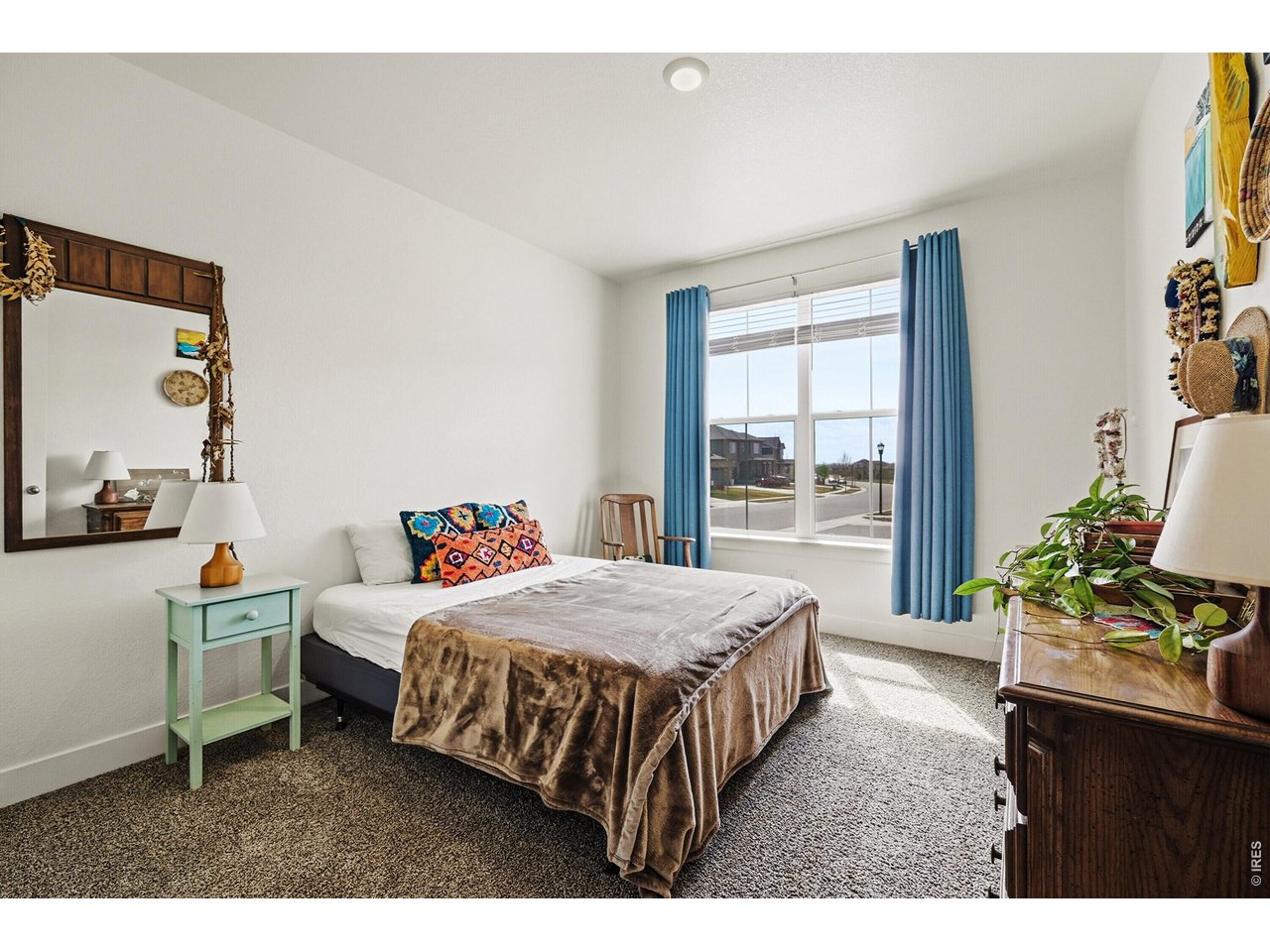 1699 Rivergate Way Berthoud, CO 80513 - Photo 19 of 45 a bedroom with a bed table and a window