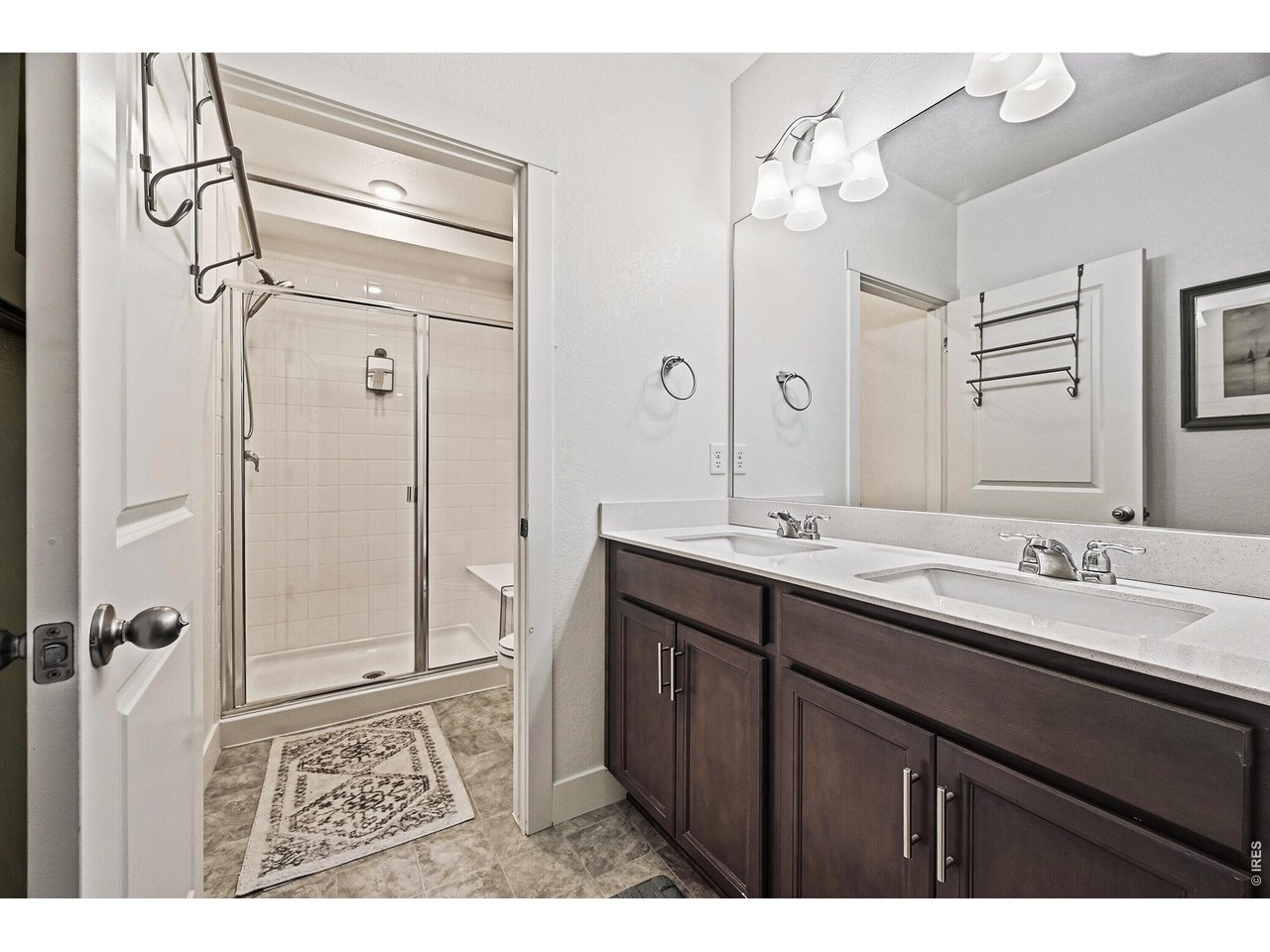 1699 Rivergate Way Berthoud, CO 80513 - Photo 25 of 45 a bathroom with a double vanity sink mirror and double