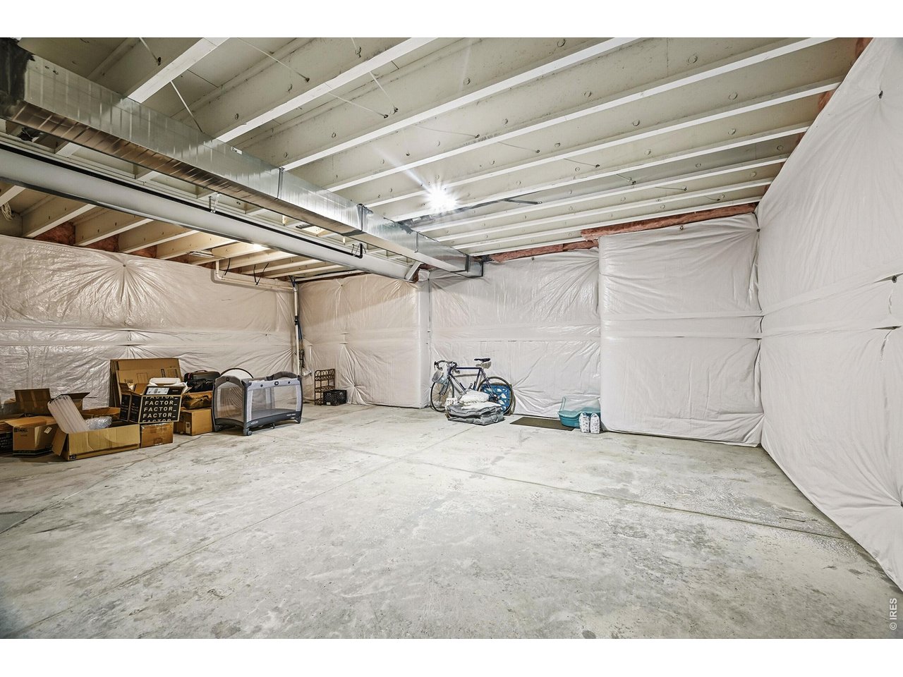 1699 Rivergate Way Berthoud, CO 80513 - Photo 27 of 45 a view of a garage with cars