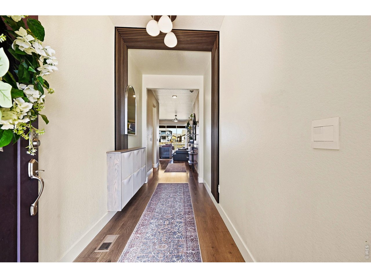 1699 Rivergate Way Berthoud, CO 80513 - Photo 4 of 45 a hallway with a wooden floor