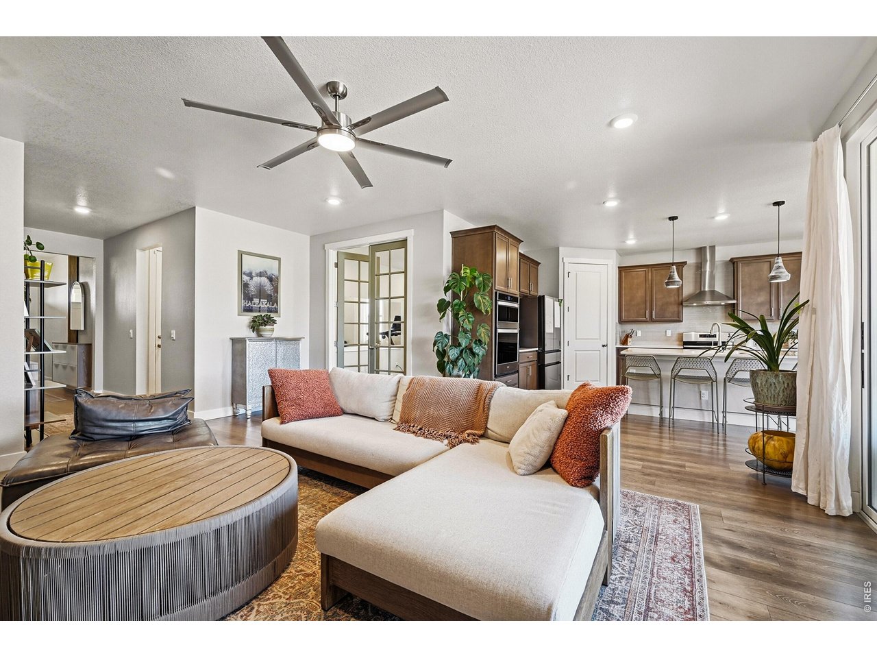 1699 Rivergate Way Berthoud, CO 80513 - Photo 6 of 45 a living room with furniture and a wooden floor
