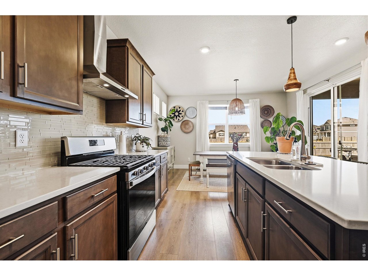 1699 Rivergate Way Berthoud, CO 80513 - Photo 9 of 45 a kitchen with stainless steel appliances granite countertop a sink stove and cabinets